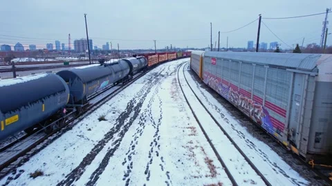 Freight train, laden with cargo along a railway in urban setting. Canadian .. Stock Footage 263685247