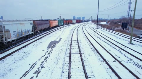 Freight train, laden with cargo along a railway in urban setting. Canadian .. Stock Footage 263685249