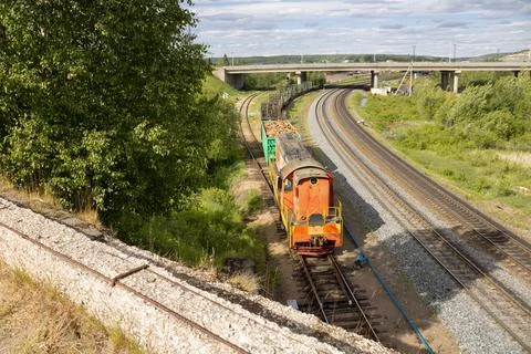 Freight train with loaded and empty carriages, several railroad tracks Stock Photos