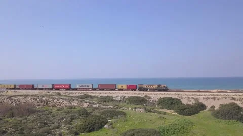 Freight Train loaded freight Containers crossing a green pasture. Stock Footage 133138029
