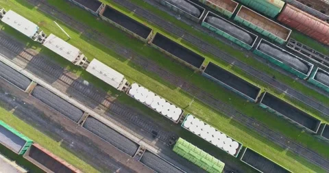 A freight train moves across a railway station frame with rotation from above Stock-Footage 147660600