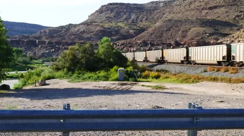 A freight train moves through the mountains. Stock Footage 54077080