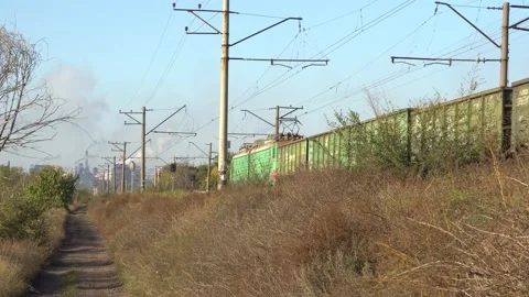 Freight train moves towards the industrial district of the city Stock Footage 143273548
