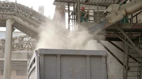 A freight train is moving along the rails at the factory, and stones are falling Video stock 156388219