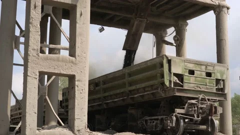 A freight train is moving along the rails at the factory, and stones are falling Video stock 156388223
