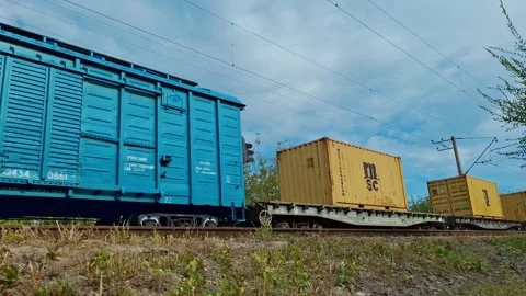 Freight train is moving along railway, transporting productions in containers Stock-Footage 319130067