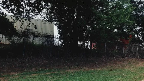 Freight Train Moving Barbed Wire fence Cinematic Establishing Shot Stock Footage 91899117