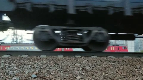 A freight train is moving, heavy wheels, rails and sleepers are visible Stock Footage 160096517
