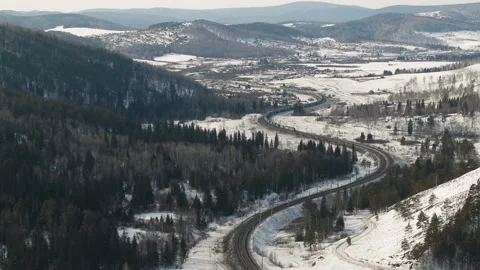 Freight train moving on railway tracks winter landscape, Aerial view Stock Footage 104304130