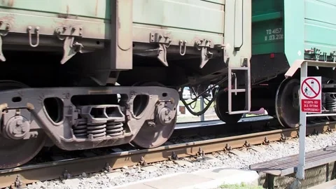 Freight train moving slowly across a small bridge Stockbeeldmateriaal 136916075