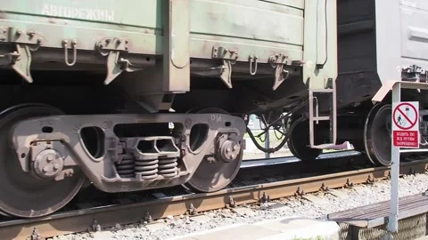 Freight train moving slowly across a small bridge Stock Footage 136916094