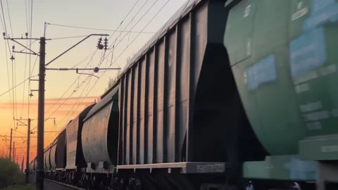 Freight Train Moving at Sunset with Tank and Cargo Wagons | Railway Stock Footage 334813346