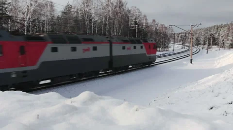 Freight train moving through the winter forest, Russia Stock Footage