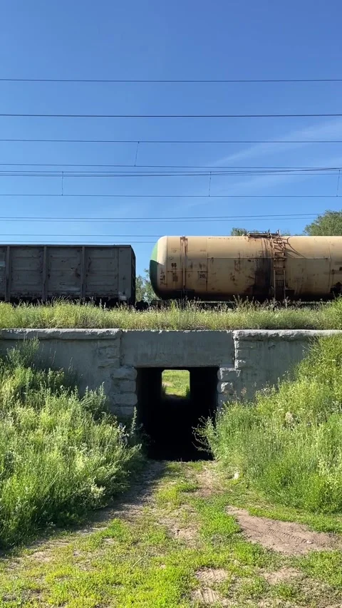 Freight train with multi-colored oil tank cars and containers Stock Footage 281641493