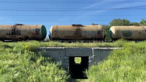 Freight train with multi-coloured oil tank cars and containers Stock Footage 281641624