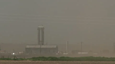 Freight train passes farm in blowing dust Stock Footage 51273961