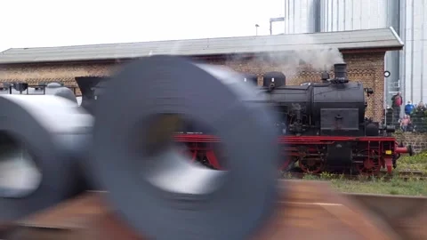 A freight train passes in front of steam locomotive 78468  Stock Footage 169353460