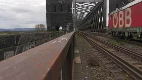 A freight train passes a level crossing with closed gates Stock Footage 256500728