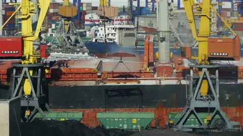 Freight train passes near the docked ship in trading port Video stock 34736733
