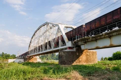 Freight train passes over the bridge Stock Photos