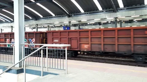 Freight train passes by the passenger station. Stock Footage 263910122