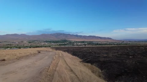 Freight Train Passes Scorched Hillsides Outside Winnemucca, Nevada at Dusk Stock Footage 320356330