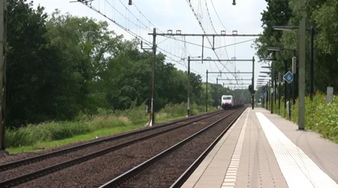 Freight train passes station Stock Footage 39814681