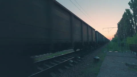 Freight Train Passing Close Wide Angle Shot | Cargo Railcars Moving Fast at Dusk Stock Footage 341160840