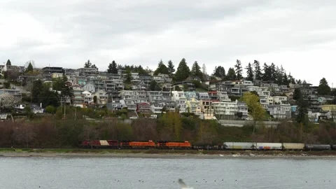 Freight Train Passing Coastal Community, White Rock Beach, April 7, 2024, BC, Ca Stock Footage 271384149