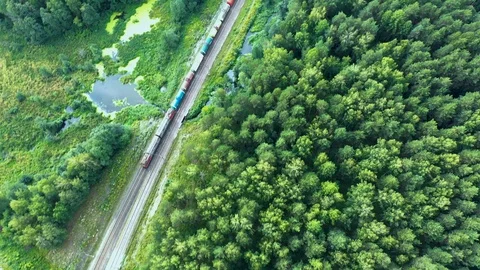 Freight train passing at the double line railway with freight wagons. Evergreen 스톡 동영상 112949964