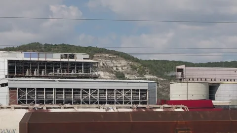 Freight train passing an industrial plant facility Stock Footage 345928282