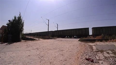 Freight train passing over a facility for passing cars over the railway equipped Stock Footage 60798969