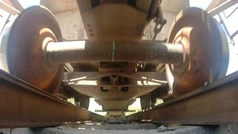 Freight train passing over railway, view from underneath (4K) Stock Footage 127763638