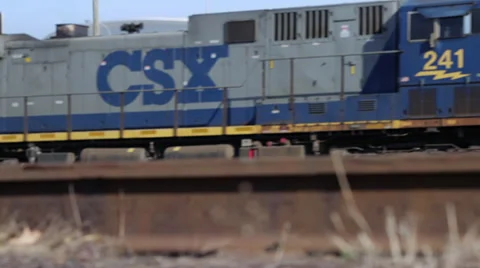 Freight train passing by in Philadelphia area with track in foreground Stock Footage 36971074
