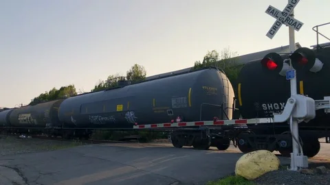 Freight Train Passing By a Railroad Crossing Stock Footage 101216228