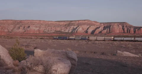 Freight Train Passing Red Cliffs in Gallup New Mexico Stock Footage 341663411