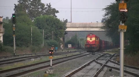 A Freight train is passing by a rural station in India Stock Footage 11352770