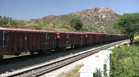 A Freight train is passing by a rural station in India Stock Footage 18414667