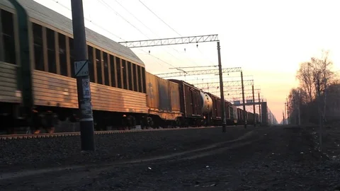 A Freight train is passing by a rural station in sunset light. Stock Footage 74541630