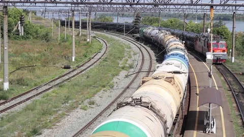 Freight train passing by the station on a sunny summer day top view Stock Footage 138174991