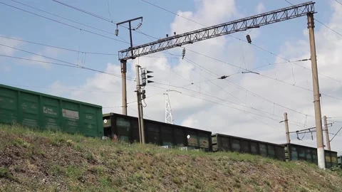 Freight train passing by the station on a sunny summer day close up Stock Footage 138175035