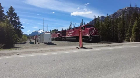 Freight train passing through Banff on a bright summer day 스톡 동영상 156628908