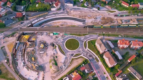 A freight train is passing through a construction site for an underpass Stock Footage 335268378