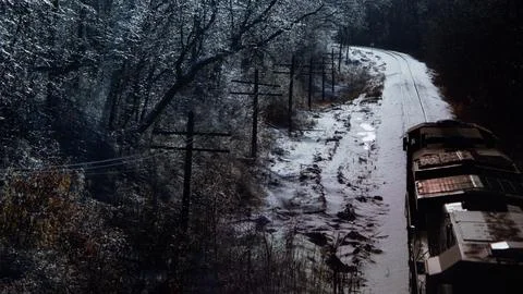 Freight train passing through magical woodlands after an ice storm. Stock Photos