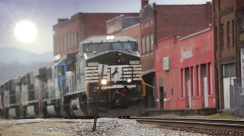 Freight Train passing through Mid-West Town Stock Footage 33423260