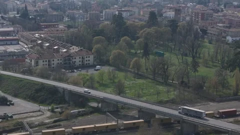 Freight train passing through Pontenure near road bridge in Piacenza Province Stock Footage 336257541