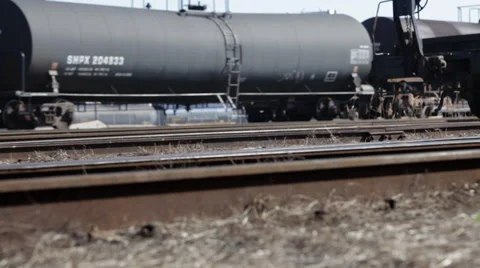 Freight train passing by with tracks in foreground Stock Footage 36948869