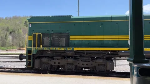 Freight train passing a train station in Europe - Slovenia Stock Footage 278722677