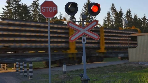 Freight train at rail road crossing Stock-Footage 75786357