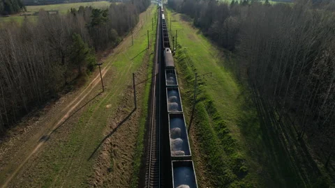 Freight train on railway, aerial view. Freight Cars Deliver bulk Materials Stock Footage 190077810
